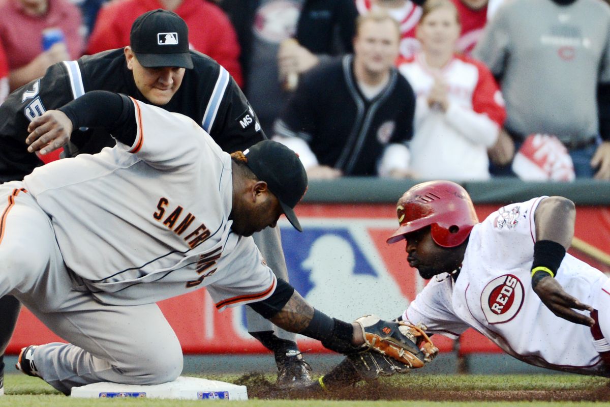 Giants third baseman Pablo Sandoval tags out Brandon Phillips at third base in the first inning of close game in Cincinnati Tuesday. (Associated Press)