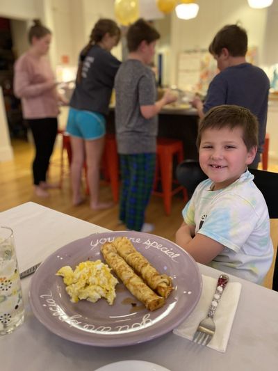 Birthday tyrant Hyrum Ditto enjoys his “birthday wish” dinner of crepes and eggs while the rest of the family dishes up their actual dinner of beef, salad and rolls.  (Courtesy of Julia Ditto)