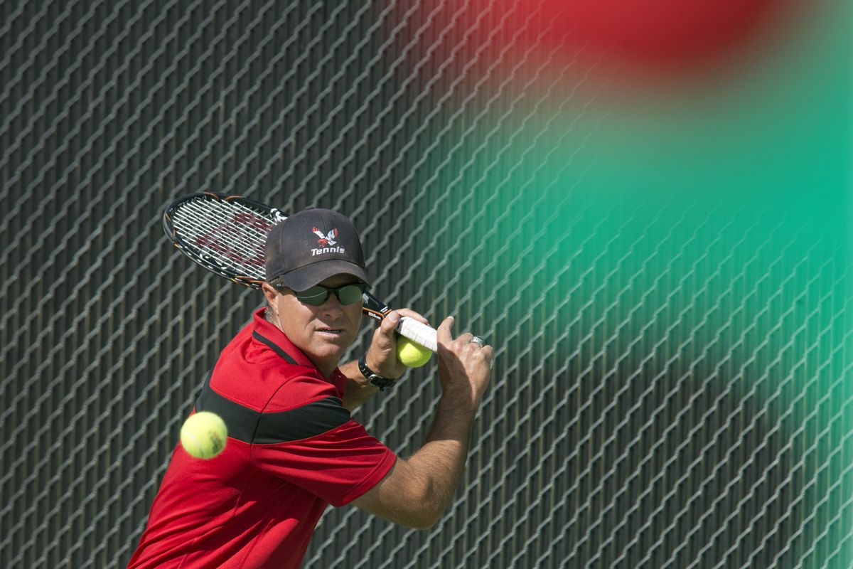 Eastern Washington University men’s tennis coach Steve Clark returns volley to Doug Clark on Friday in Cheney. (Dan Pelle)