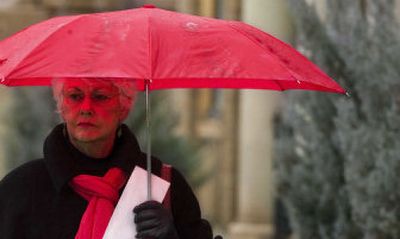 
Pam Anderson runs a quick errand on Riverside Avenue on Monday in the afternoon sleet. The rain and snow mixed in the lower elevations while snow began to stick in higher elevations in and around Spokane.
 (Kathryn Stevens / The Spokesman-Review)