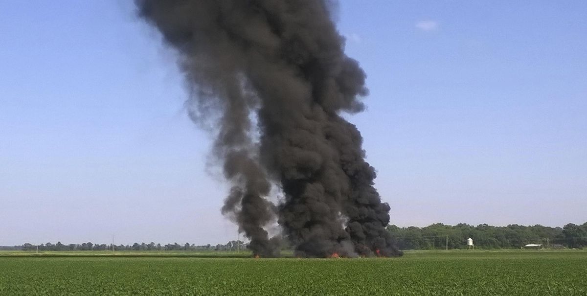 In this photo provided by Jimmy Taylor, smoke and flames come from the wreckage after a U.S. Marine refueling tanker crashed in a field Monday, July 10 near Itta Bena, Miss. At least a dozen people were killed. (Jimmy Taylor / AP)