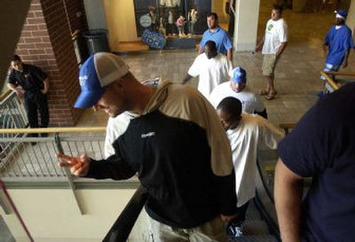 
Seahawks quarterback Matt Hasselbeck signals from the escalator to a crowd in the mall lobby. 
 (The Spokesman-Review)