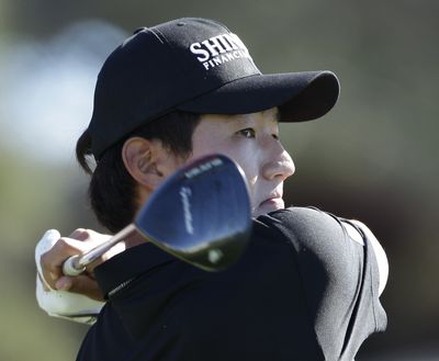First-round leader Sunghoon Kang of South Korea watches his tee shot in the first round of the Farmers Insurance Open. (Associated Press)