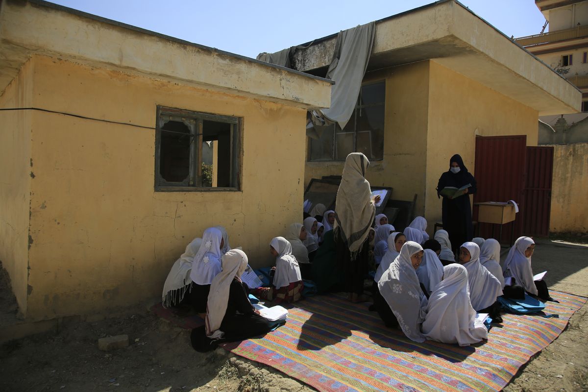 in this Wednesday, Oct. 7, 2020, students attend an open air class at a primary school in Kabul, Afghanistan, An Afghan education ministry memo banning girls, 12 years old and older, from singing at public school functions, which the education ministry tells The Associated Press was a mistake, is causing a social media stir. (Associated Press)