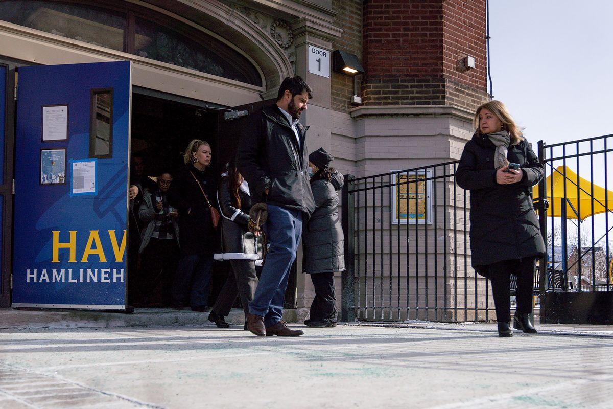 Chicago Public Schools Chief Education Officer Bogdana Chkoumbova, right, walks out of Hamline Elementary School on Friday in Chicago.  (Audrey Richardson/Chicago Tribune/TNS)