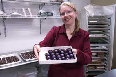 
Julia Balassa-Myracle shows off some huckleberry truffles. Her business, based out of her home, is called Chocolate Myracles. 
 (J. BART RAYNIAK / The Spokesman-Review)