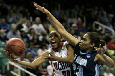 
UConn guard Renee Montgomery dips a shot under T.J. Jordan.Associated Press
 (Associated Press / The Spokesman-Review)