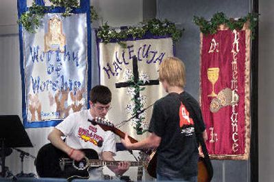 
Grant Callant, left, and Brendan Heikklla play guitars for the devotion part of the daily program for students taking part in the World Changers program at the Airway Heights Baptist Church on Thursday. 
 (The Spokesman-Review)