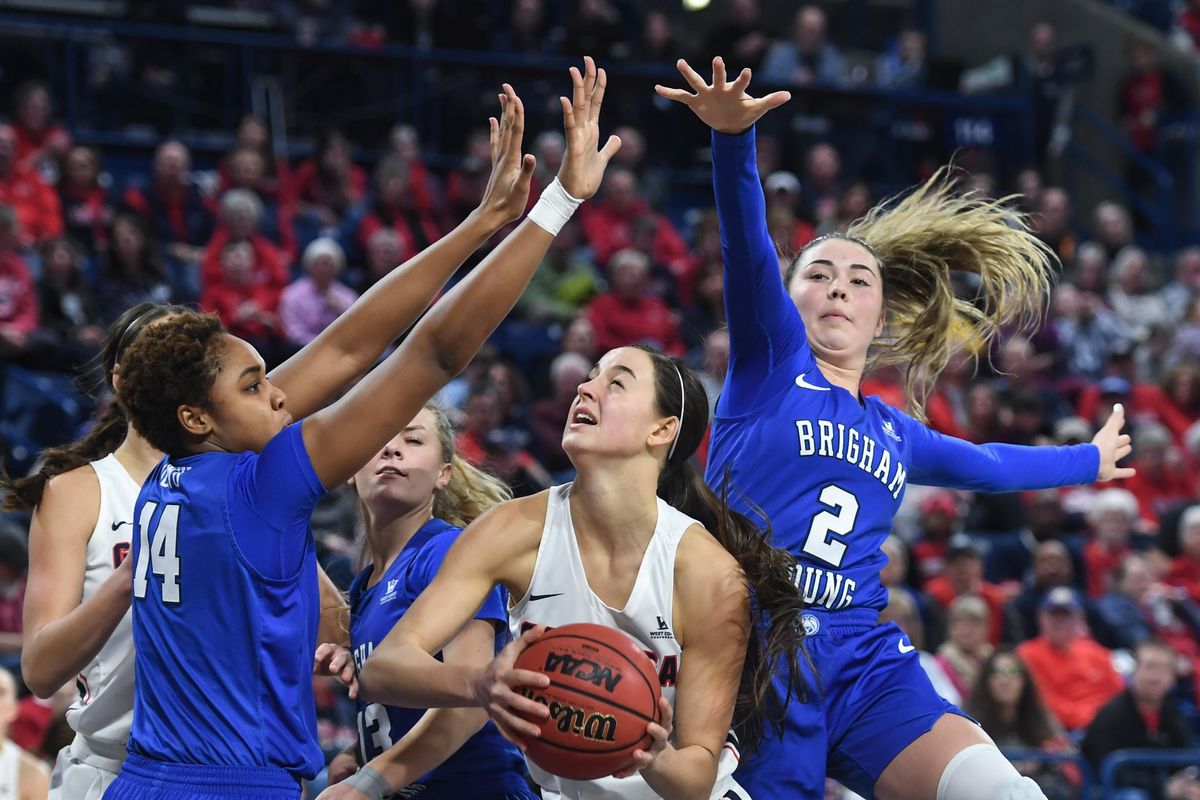 Gonzaga forward LeeAnne Wirth splits BYU forward Babalu Ugwu (14) and guard Shaylee Gonzales (2), Saturday, Feb. 16, 2019, in the McCarthey Athletic Center. (Dan Pelle / The Spokesman-Review)