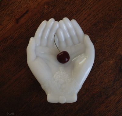 This collectible milk glass tray holds a ripe Northwest cherry from the year's abundant season (Cheryl-Anne Millsap / photo by Cheryl-Anne Millsap)