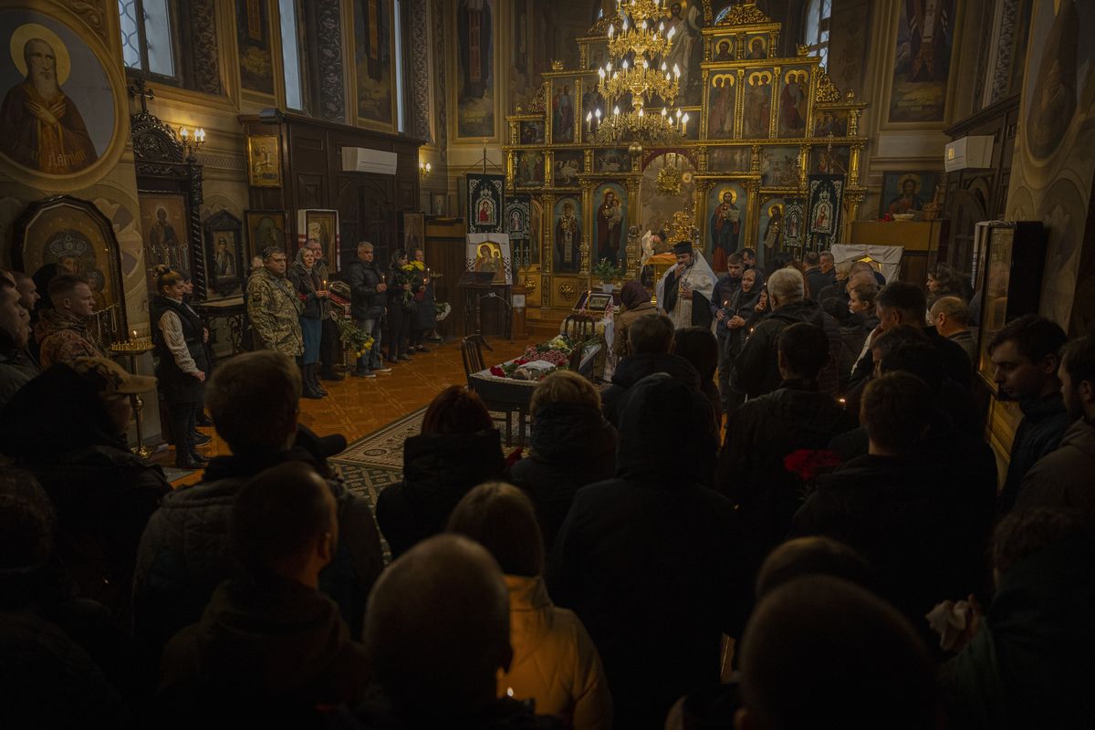 Relatives, friends and fellow service members gather Wednesday at the St. Feodosiivsky Monastery in Kyiv for the funeral of 128th Mountain Assault Brigade soldier Mykyta Vlaskov.    (Serhiy Morgunov/For The Washington Post)