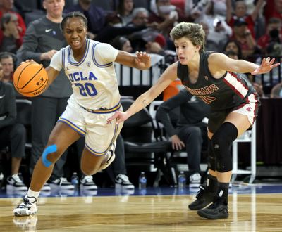 UCLA’s Charisma Osborne drives against Washington State’s Astera Tuhina in the Pac-12 Tournament title game March 5 in Las Vegas.  (Getty Images)