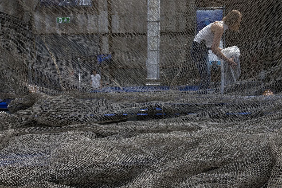 People prepare for the news  conference of the Ocean Cleanup foundation in Utrecht, Netherlands, Thursday, May 11, 2017. The foundation aiming to rid the world’s oceans of plastic says it will start cleaning up the huge patch of floating junk known as the Great Pacific Garbage Patch within the next 12 months, two years ahead of schedule. (Peter Dejong / Associated Press)