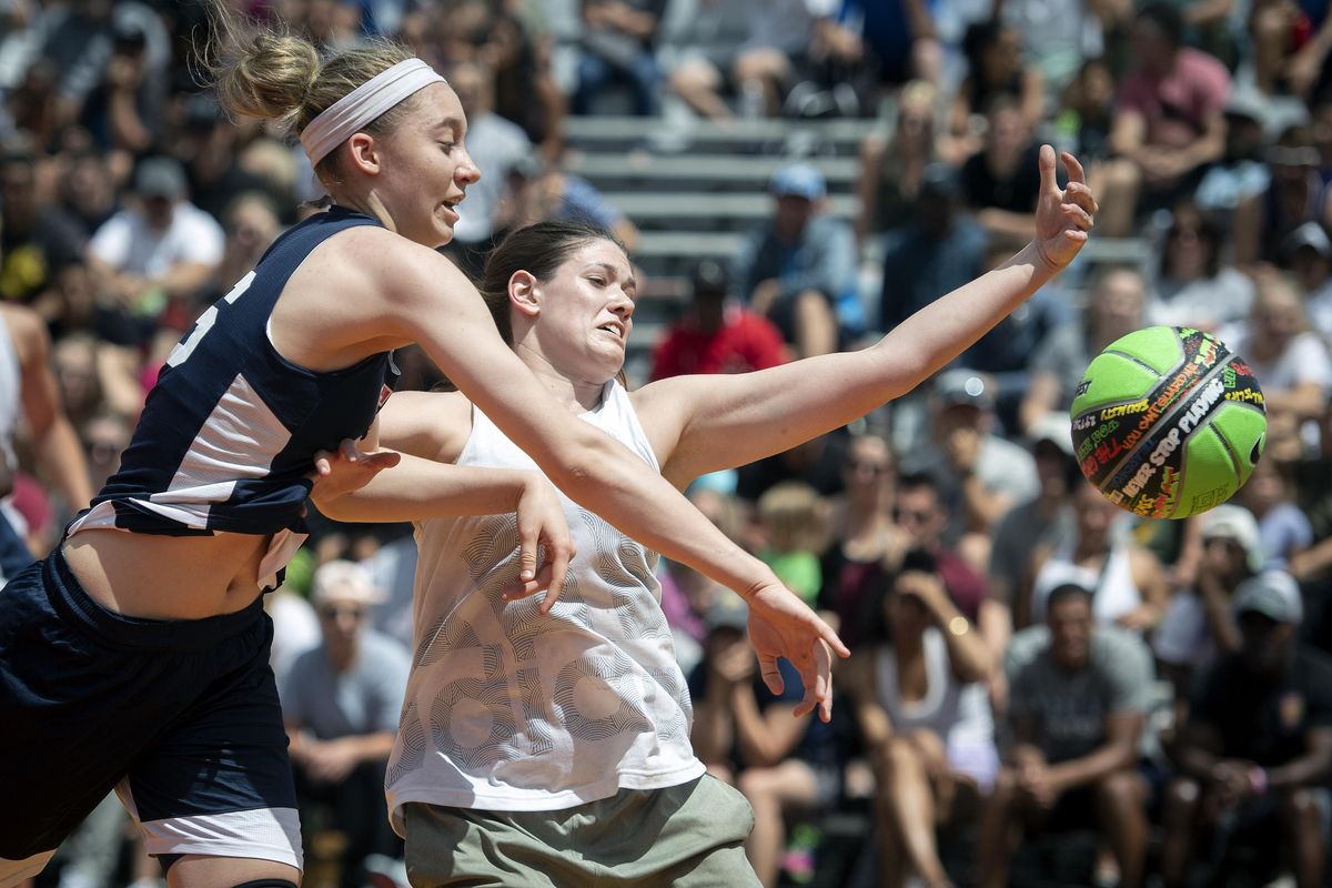 Stars and Stripes’ Paige Buechers knocks the ball away from Robyn Buna of YYC Canada during the Hoopfest women’s elite championship game at Nike Center Court Sunday. Stars and Stripes won 20-15. (Colin Mulvany / The Spokesman-Review)