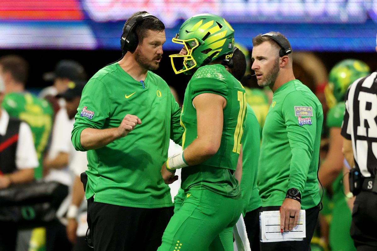 Oregon coach Dan Lanning talks with quarterback Bo Nix during Saturday’s game against Georgia in Atlanta. (Tribune News Service)