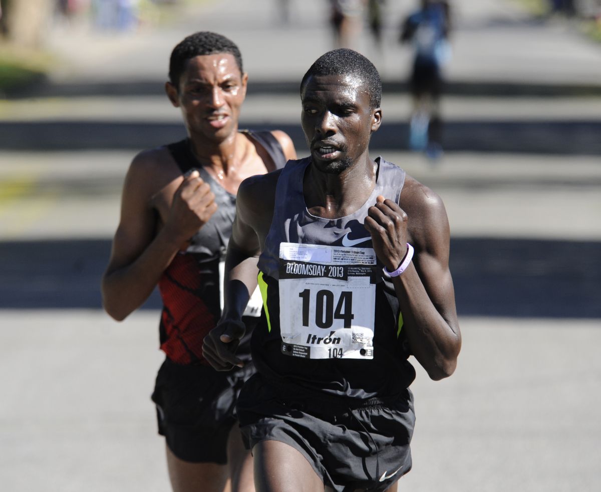 Kenyan Emmanuel Better, right, looks back at eventual winner of Bloomsday 2013, Ethiopian Balete Assefa, left, running south on Lindeke Sunday, May 5, 2013 at Bloomsday 2013. It was a two-man race for the last half. (Jesse Tinsley / The Spokesman-Review)