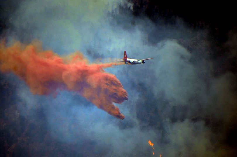 A plane drops fire retardant on a forest fire in Colorado. (Associated Press)