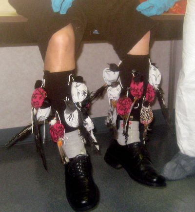 ORG XMIT: LA114 This undated photo provided by the Department of Justice shows detained suspect Sony Dong, with songbirds strapped to his legs at Los Angeles International Airport. Dong was charged Tuesday, May 5, 2009 with smuggling song birds into the United States by strapping more than a dozen of them to his legs and trying to walk out of the Los Angeles International Airport. (AP Photo/Department of Justice) (The Spokesman-Review)