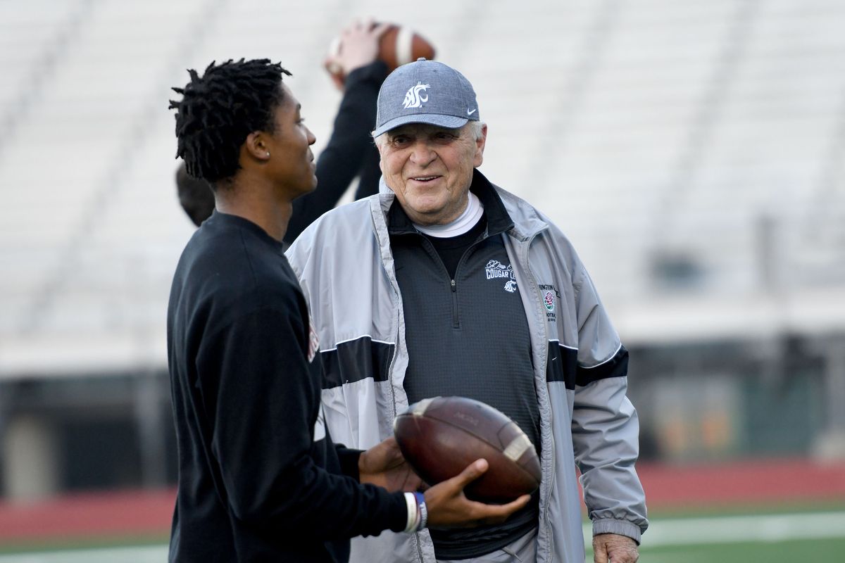 Former Washington State coach Mike Price talks with Rogers sophomore Aaron Kinsey during the Price Elite Passing Academy. Roughly 100 high school football players attended the camp.  (Kathy Plonka / The Spokesman-Review)