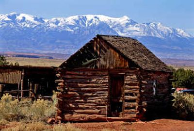 
Joe Biddlecome's cabin at Biddlecome-Ekker Ranch in Robbers Roost sits pristinely with the Henry Mountains in the background. Los Angeles Times
 (Los Angeles Times / The Spokesman-Review)