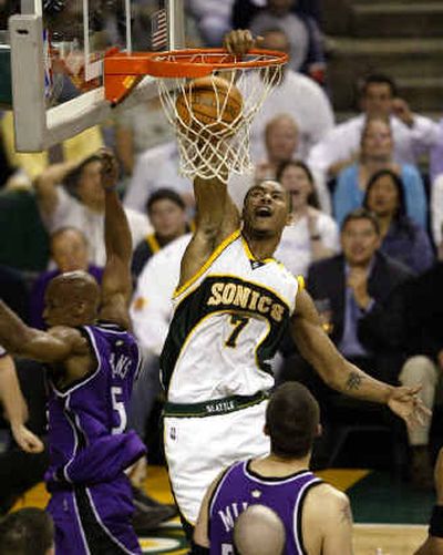 
Seattle SuperSonics forward Rashard Lewis (7) dunks after Sacramento Kings guard Maurice Evans, left, missed the block in the second quarter. 
 (Associated Press / The Spokesman-Review)