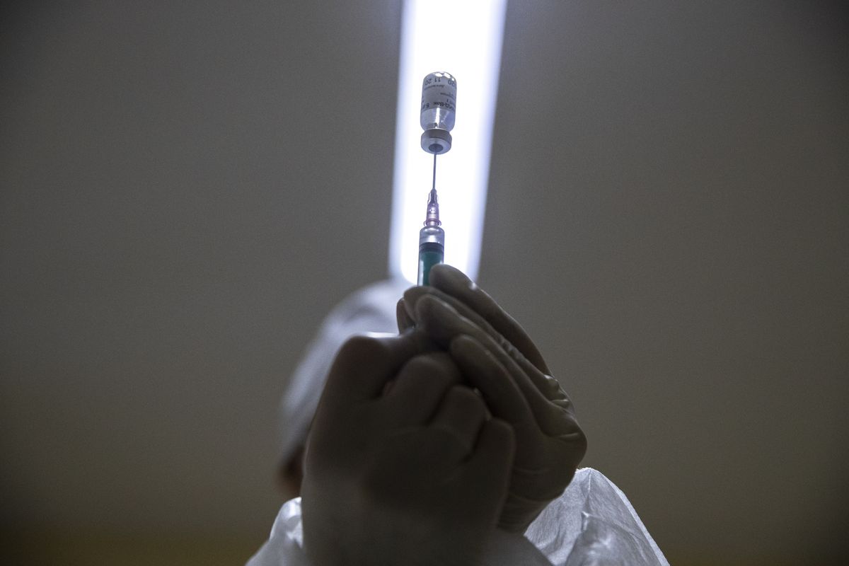 In this Wednesday, Dec. 30, 2020 photo, a medical worker prepares a shot of Russia