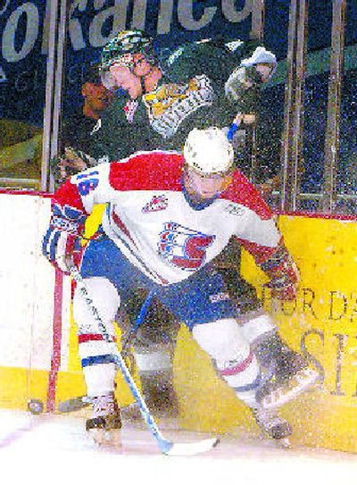 
Spokane's J.P. Szaszkiewicz checks Everett's Dane Crowley into the boards. 
 (J. Bart Rayniak / The Spokesman-Review)