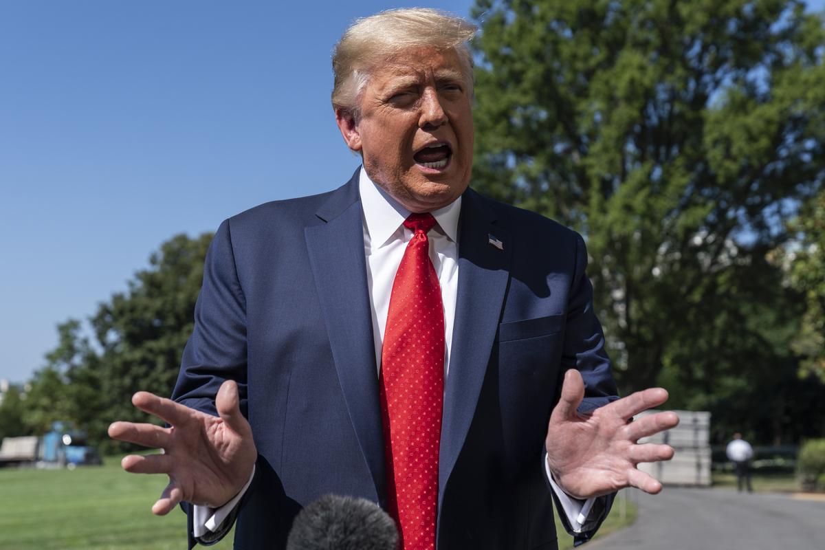 President Donald Trump speaks with reporters as he walks to Marine One on the South Lawn of the White House, Monday, Aug. 17, 2020, in Washington. Trump is en route to Minnesota and Wisconsin.  (Alex Brandon)