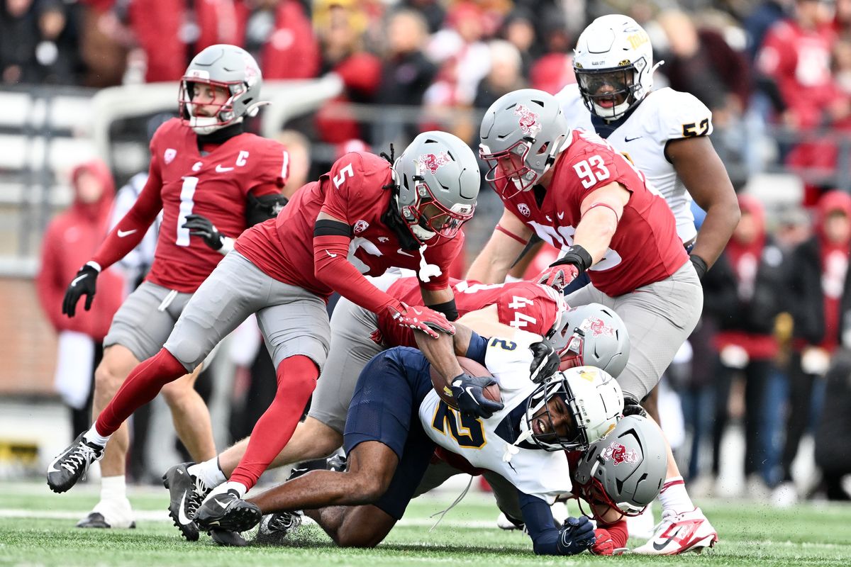 Toledo wide receiver Junior Vandeross III is brought down by the Washington State defense during a game on Saturday at Gesa Field in Pullman. (Tyler Tjomsland/The Spokesman-Review)