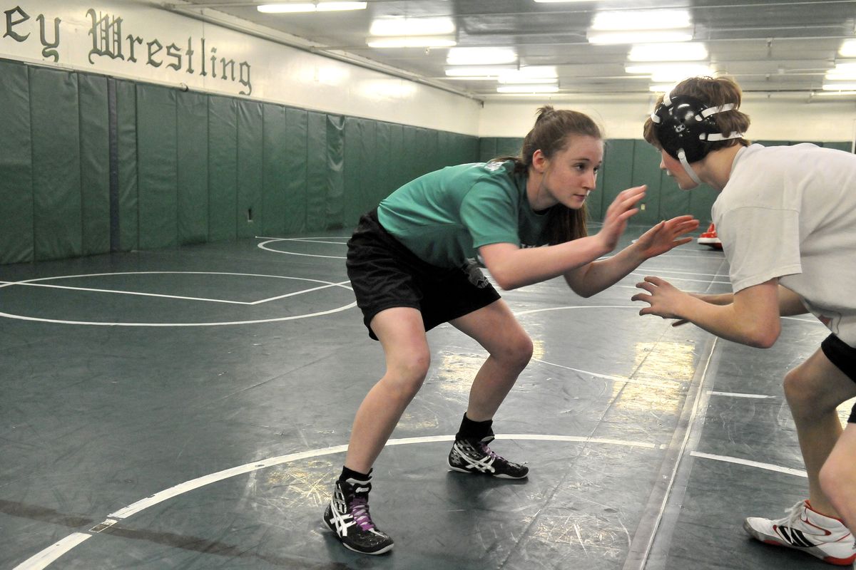 Rachael Coleck, left, who placed in the state tournament at 118 pounds, practices moves with Zac Hanson in an off-season workout Feb. 28 at East Valley High School. Coleck’s opponents are female wrestlers, but througout the year, she works out with the boys. (Jesse Tinsley)