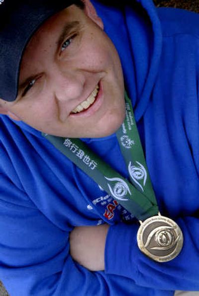
Kirk Grogan, a Spirit Lake native poses with the bronze medal he won at the Special Olympics World Summer Games in China. 
 (Kathy Plonka / The Spokesman-Review)