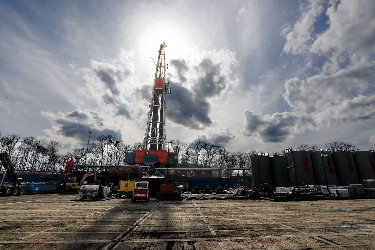 FILE - In this March 12, 2020, file photo, the sun shines through clouds above a shale gas drilling site in St. Mary