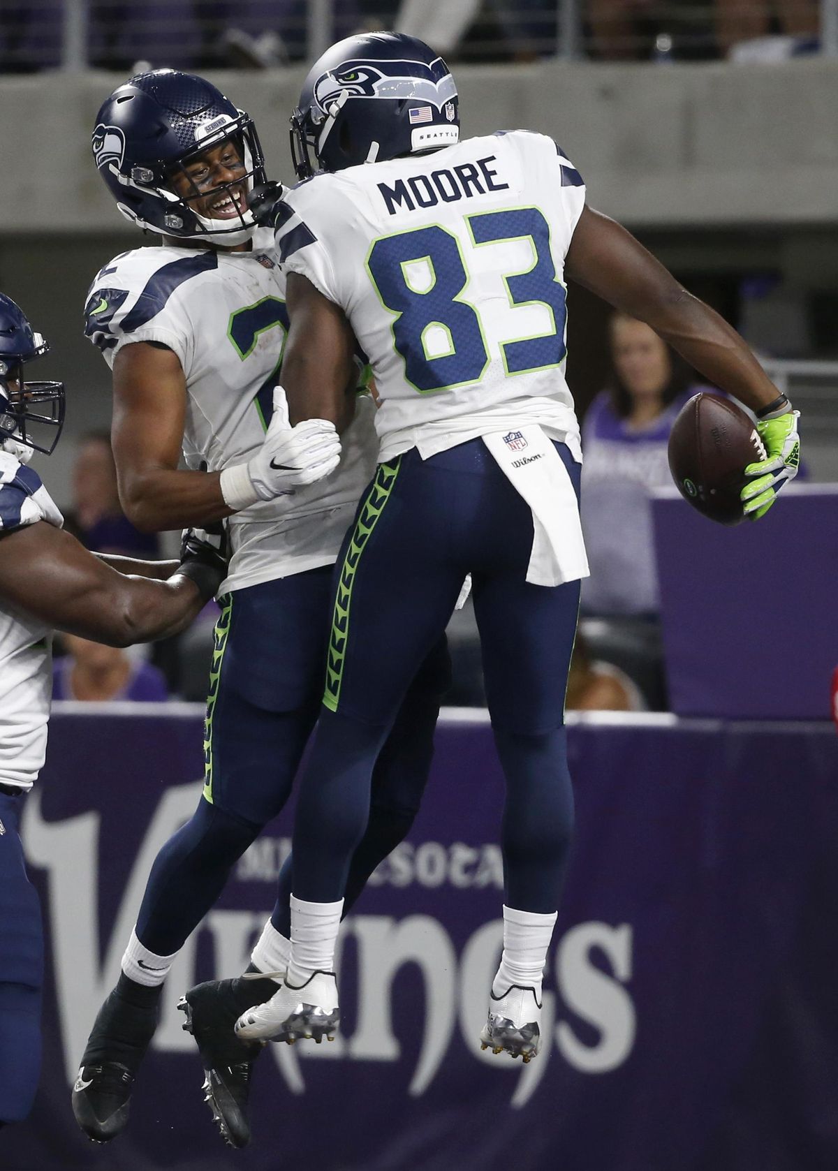 Seattle Seahawks wide receiver David Moore celebrates with teammate C.J. Prosise after catching a 36-yard touchdown pass during the second half of Friday’s NFL preseason game against the Minnesota Vikings in Minneapolis. (Bruce Kluckhohn / AP)