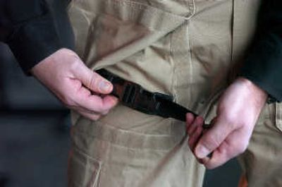 
Mike Noell, CEO of BlackHawk,  demonstrates the use of a built-in tourniquet in pants being tested for military use by his company. Associated Press
 (Associated Press / The Spokesman-Review)