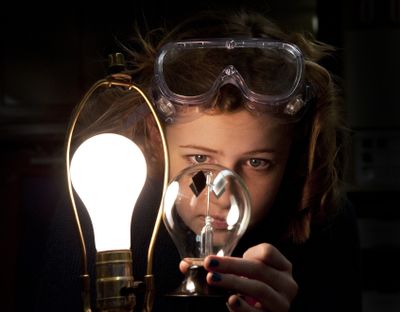 Emily Christianson, a freshman at The Community School in Spokane, measures light’s effect on a radiometer in a lab Wednesday. She and other students are planning to lead a day camp for children in El Salvador. They are also raising funds to build a library there. (Dan Pelle)