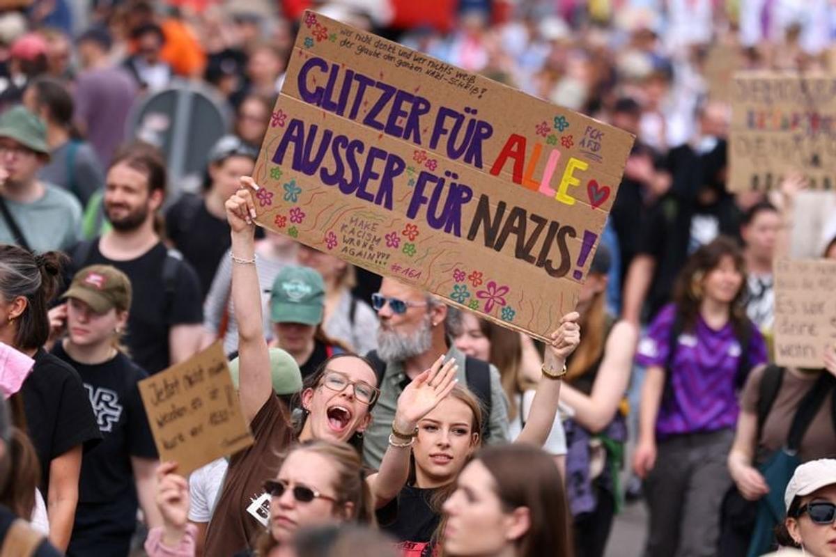 People hold a sign that reads: “Glitter for everyone, except for Nazis” during a protest against a two-day party convention of Germany’s far-right Alternative for Germany (AfD) party, in Erfurt, Germany, July 4, 2026. REUTERS/Christian Mang  (Christian Mang)