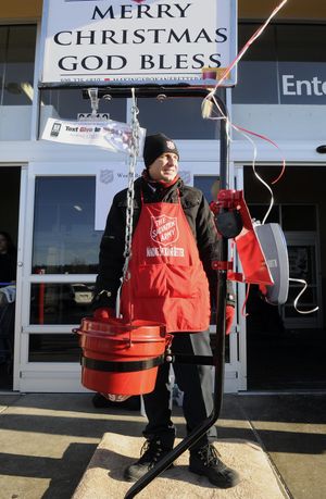 Captain Kyle Smith, of the Salvation Army, mans his post outside the Northpoint Walmart, Dec. 17,  in Spokane. Smith was trying to break the record for continuous bell ringing. He was hoping to stay for 32 hours – and did. (Dan Pelle)
