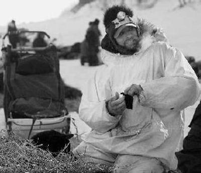 
Lance Mackey worked on his dog team last Saturday before leaving the Eagle Island checkpoint. 
 (Associated Press / The Spokesman-Review)