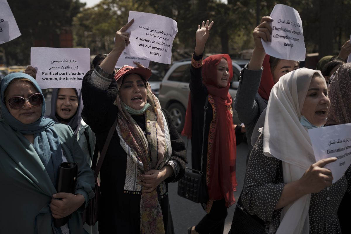 Women march to demand their rights under the Taliban rule during a demonstration near the former Women