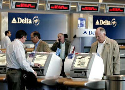 
Delta passengers check in at Logan Airport in Boston last spring. Those bumped from overbooked flights may land increased compensation, under changes being considered by the Department of Transportation.File Associated Press
 (File Associated Press / The Spokesman-Review)