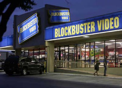 Customers enter a Blockbuster store in Dallas. Blockbuster Inc. on Thursday said its third-quarter loss widened, partly on severance and lease termination costs. The movie-rental company said it is planning job cuts to boost profitability.  Associated Press file photos
 (Associated Press file photos / The Spokesman-Review)