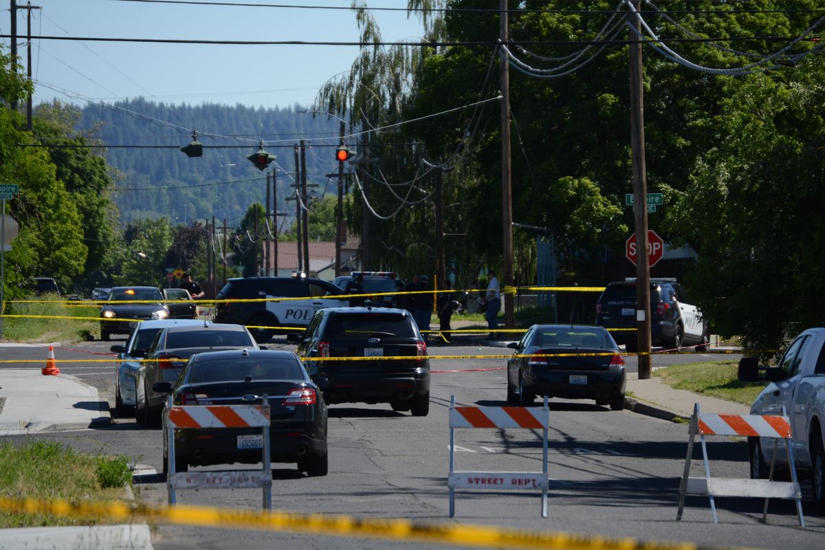 Spokane police investigate the Perry Street area after reports of multiple drive-by shootings Sunday, June 26, 2022.  (Greg Mason / The Spokesman-Review)