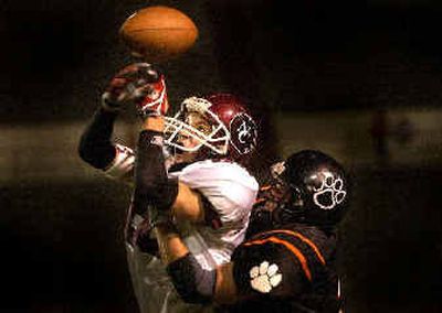 
North Central player Steve Bargel bobbles the ball before coming down with a completion despite tight coverage by Lewis and Clark's Kevin Luby.
 (Brian Plonka / The Spokesman-Review)