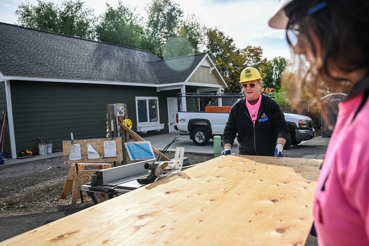 Habitat For Humanity volunteer Jessica Todd (center) cuts a board during project Oct. 9 in Spokane Valley.  (Kathy Plonka/The Spokesman-Review)