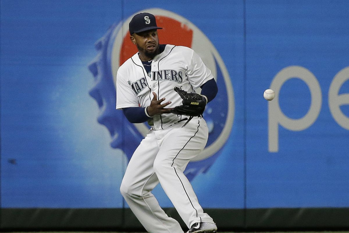 Mariners left fielder Rickie Weeks drops a fly ball in the ninth inning as Boston scores go-ahead run. (Associated Press)