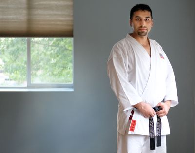 Kazim, an immigrant from Afghanistan, poses for a photo on June 24 at his karate dojo in Spokane. Kazim's brother fled Afghanistan for Washington in August, but he's worried about other family members in the country as the Taliban takes over.  (Tyler Tjomsland/The Spokesman-Review)