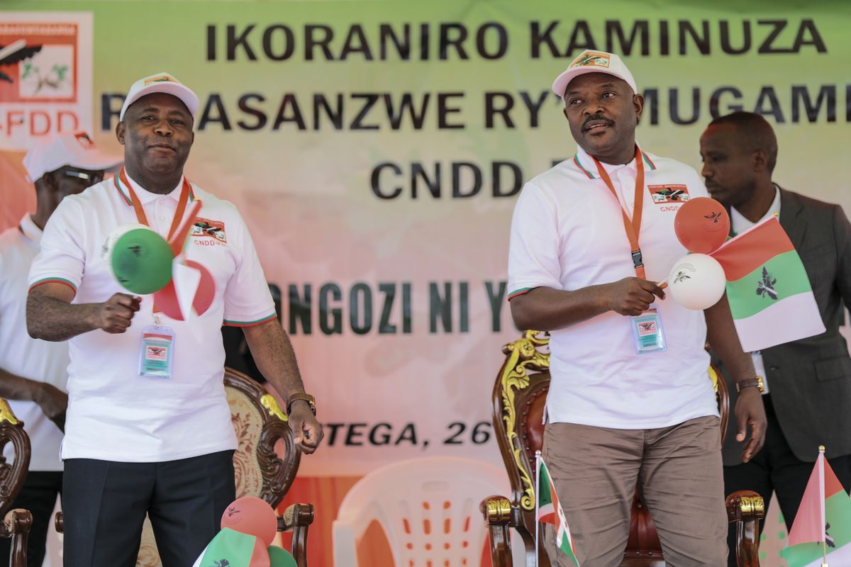 FILE - In this Jan. 26, 2020, file photo, Burundi Army Gen. Evariste Ndayishimiye, left, is accompanied by president Pierre Nkurunziza, right, after Ndayishimiye was chosen as the party