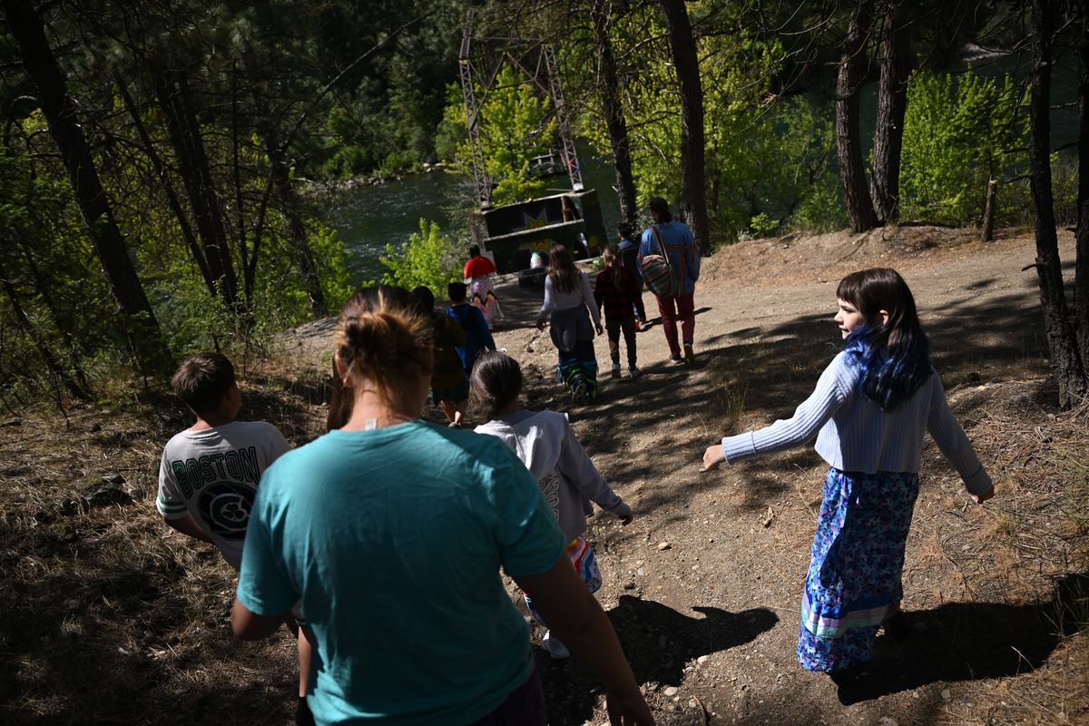 Salish School of Spokane students explore a path to the Spokane River where the school’s new campus will be built on Wednesday, May. 21, 2025, in Spokane, Wash.  (Tyler Tjomsland/The Spokesman-Review)