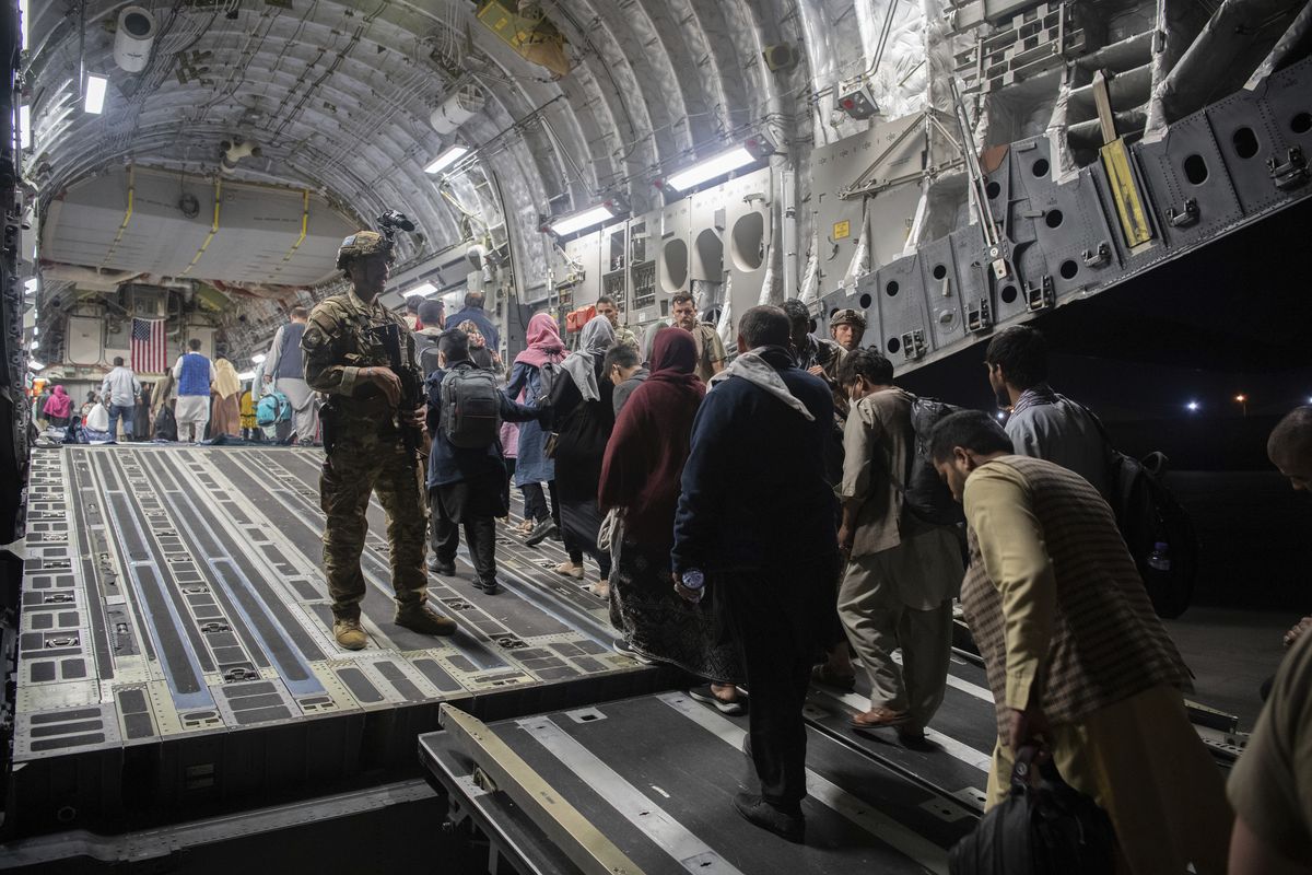 In this Aug. 22, 2021, photo provided by the U.S. Air Force, Afghan passengers board a U.S. Air Force C-17 Globemaster III during the Afghanistan evacuation at Hamid Karzai International Airport in Kabul, Afghanistan.  (MSgt. Donald R. Allen)
