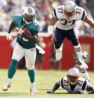 Dolphins RB Ronnie Brown ran for four TDs and threw for another out of wildcat formation last season against the Patriots.  (Associated Press / The Spokesman-Review)